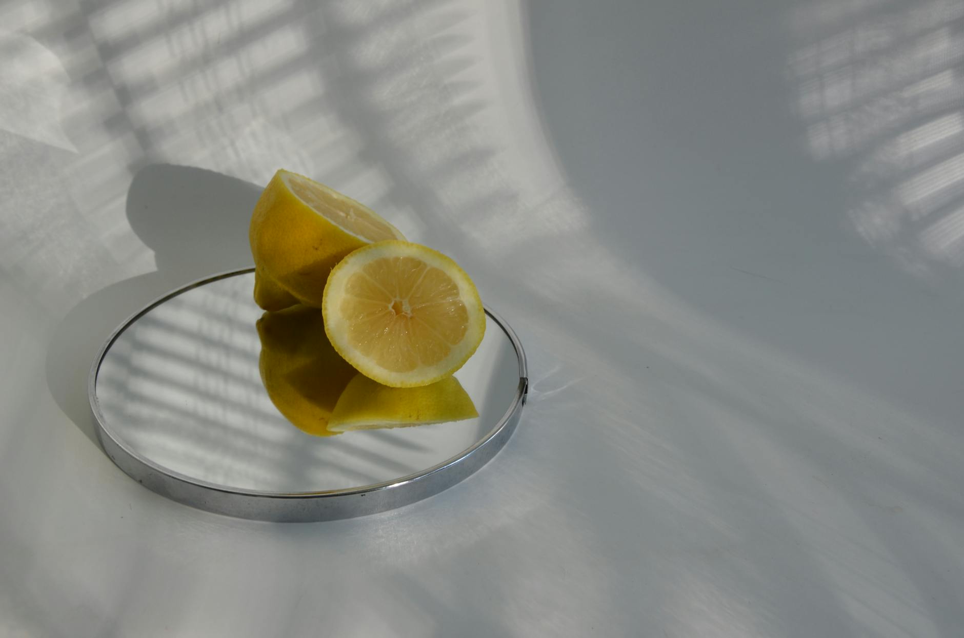 Close-up of a hand holding an orange vibrator against a minimalistic purple backdrop
