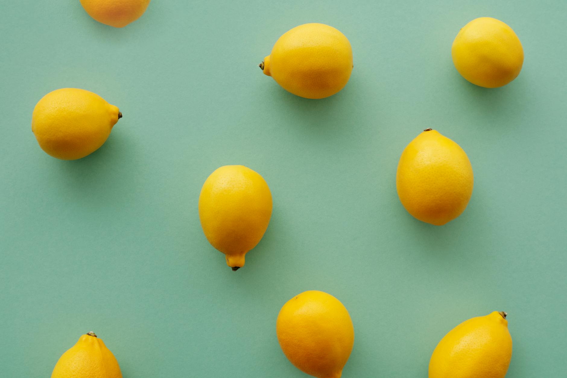 Bright yellow lemons arranged on a pastel background representing fresh, easy care