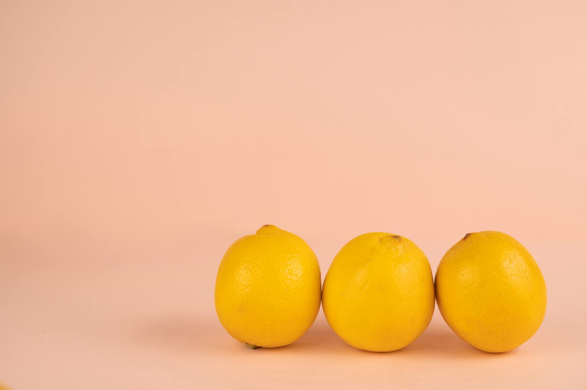 Bright ripe lemons on a pastel background representing fresh pleasure and vibrant sensation